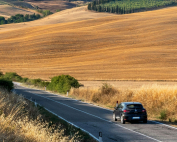 Coche circulando por una carretera en un entorno rural